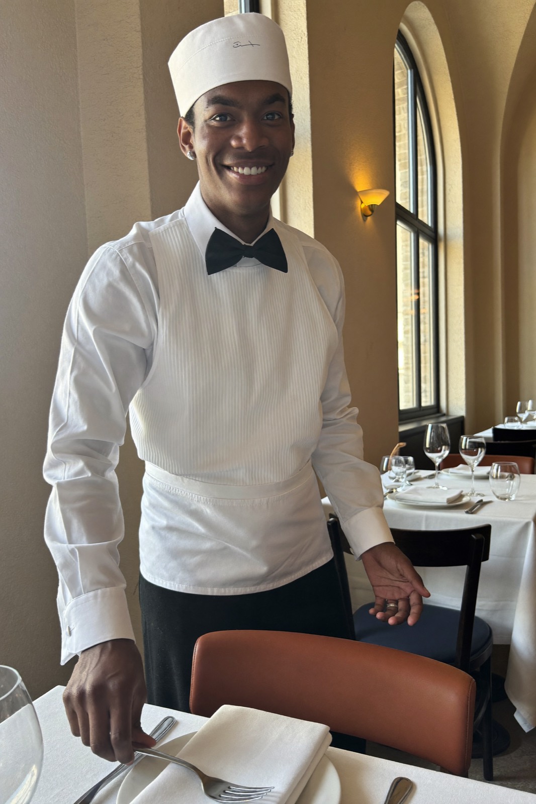 A waiter setting a table